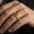 Load image into Gallery viewer, Gold plated Maltese cross spinner band worn on finger, bold cross motif on rotating band, premium lifestyle jewelry photo.
