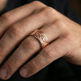 Load image into Gallery viewer, Rose gold plated Maltese cross spinner ring worn on finger, sculpted cross relief with decorative borders, elegant lifestyle wear shot.
