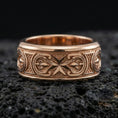 Load image into Gallery viewer, Rose gold plated sterling silver Maltese cross spinner ring on volcanic stone, sculpted cross relief with deep contrast and decorative borders, minimal high-end close-up.

