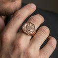 Load image into Gallery viewer, Sterling silver Armenian coat of arms signet ring on a finger, macro lifestyle shot featuring the rose gold plated finish and engraved heraldic emblem details
