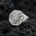 Load image into Gallery viewer, Sterling silver Armenian coat of arms signet ring in a polished silver finish, detailed heraldic emblem with shield, eagle and lion relief, close-up on volcanic stone
