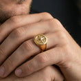 Load image into Gallery viewer, Sterling silver nautical compass ring worn on a finger, close-up lifestyle photo showcasing the gold plated finish and engraved cardinal direction symbols

