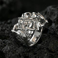 Load image into Gallery viewer, Sterling silver Greek warrior statement ring in a polished silver finish, high-relief Spartan soldiers design with helmets, shield, and raised weapons, close-up on volcanic stone
