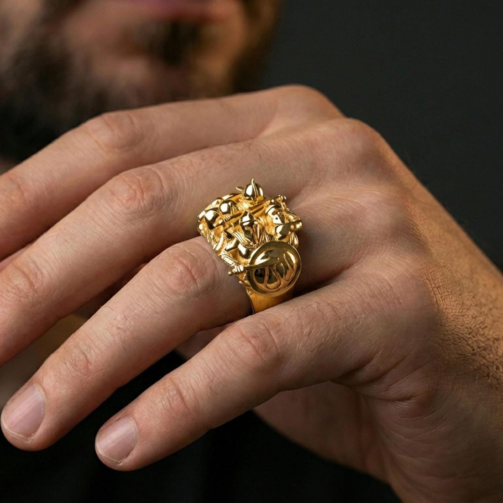 Sterling silver Spartan battle ring worn on a finger, close-up lifestyle photo showcasing the gold plated finish and bold multi-figure warrior design
