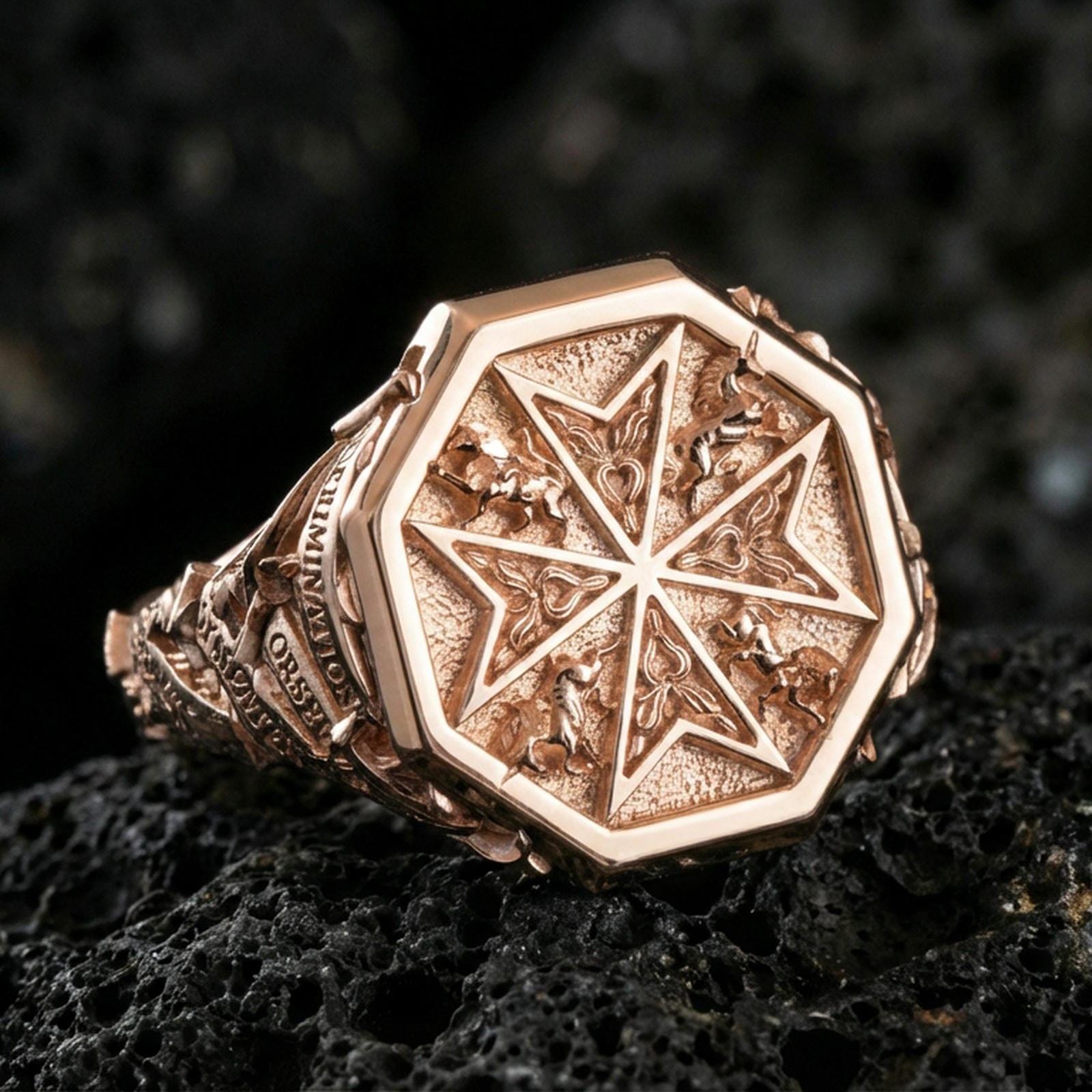 Sterling silver Templar-style cross ring with a rose gold plated finish, detailed octagonal signet top and ornate engraved band, close-up on black volcanic rock