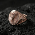 Load image into Gallery viewer, Sterling silver ancient Egypt signet ring with a rose gold plated finish, oval pharaoh portrait face and carved shoulder accents, close-up on black volcanic rock
