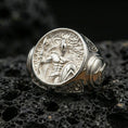 Load image into Gallery viewer, Sterling silver Spartan warrior ring in a polished silver finish, bold round signet design with detailed Greek hoplite relief and carved side accents, close-up on volcanic stone
