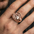 Load image into Gallery viewer, Sterling silver Greek hoplite signet ring on a finger, macro lifestyle shot featuring the rose gold plated finish and detailed warrior battle motif
