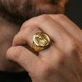 Load image into Gallery viewer, Sterling silver pharaoh ring worn on a finger, close-up lifestyle photo showcasing the gold plated finish and oval signet profile with ankh symbol
