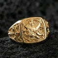 Load image into Gallery viewer, Sterling silver crusader-style lion signet ring with a gold plated finish, square statement face with lion crest and cross relief, macro product shot on volcanic rock
