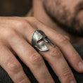 Load image into Gallery viewer, Sterling silver Spartan warrior helmet signet ring worn on a finger, close-up lifestyle shot highlighting the oxidized ancient Greek helm design and cracked texture
