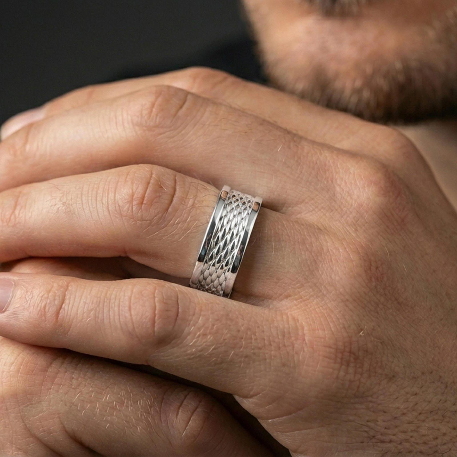 Polished silver braided rope band ring on finger, crisp woven texture and dotted border detail, refined everyday wear close-up.