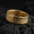 Load image into Gallery viewer, Gold plated braided rope texture band ring on volcanic rock, detailed woven pattern with clean border lines, luxury jewelry product photography.
