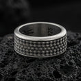 Load image into Gallery viewer, Oxidized sterling silver scale texture band ring on dark volcanic rock, repeating teardrop scale pattern with deep contrast, premium macro product shot.
