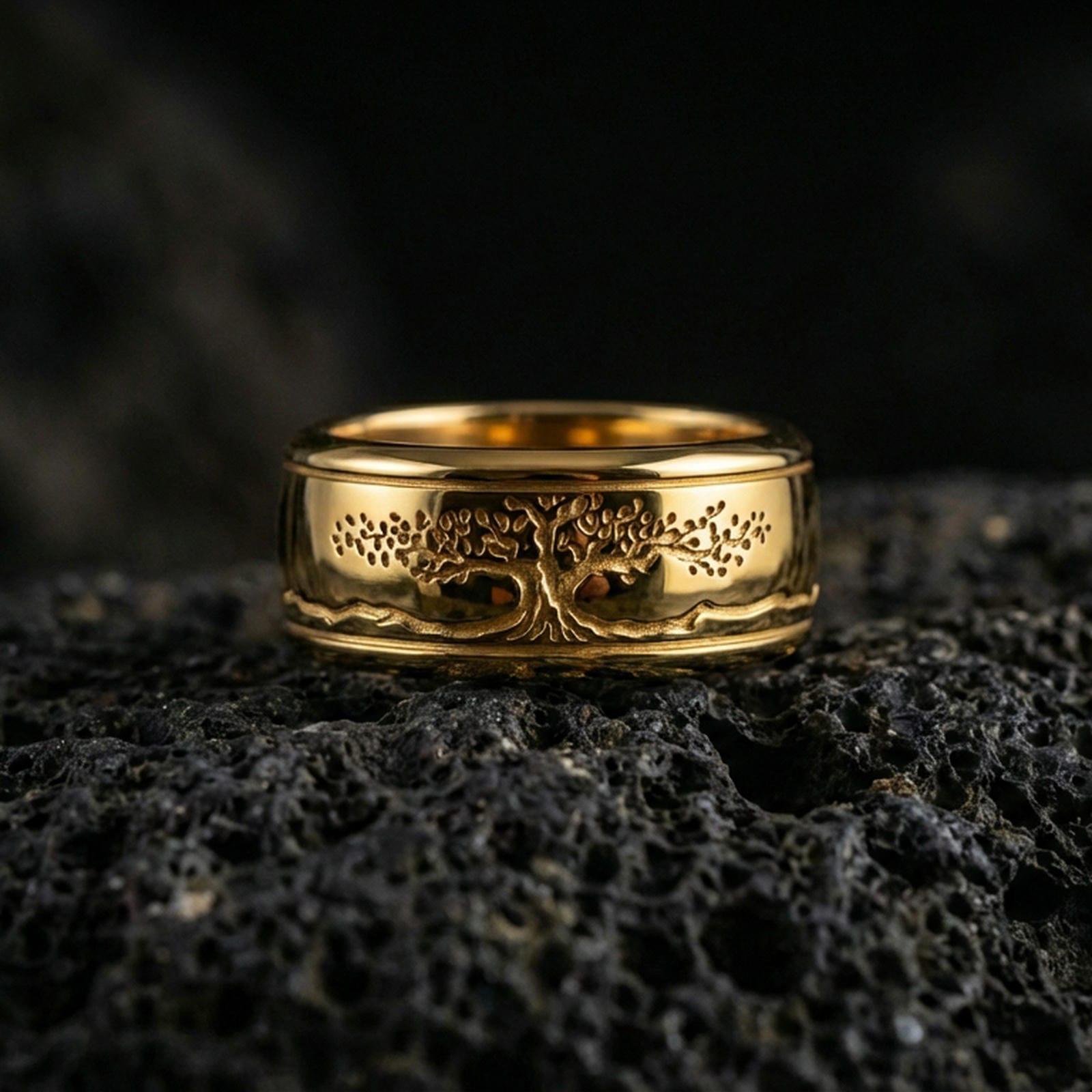 Gold plated Yggdrasil spinner band ring on volcanic rock, detailed tree of life engraving on rotating band, luxury jewelry product photography.