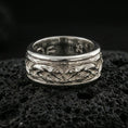 Load image into Gallery viewer, Polished silver jaguar fidget spinner ring on black volcanic stone, crisp big cat relief scene on rotating band, centered close-up studio lighting.
