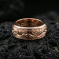 Load image into Gallery viewer, Rose gold plated sterling silver wave filigree spinner ring on volcanic stone, ornate swirl relief with deep contrast and clean borders, minimal high-end close-up.
