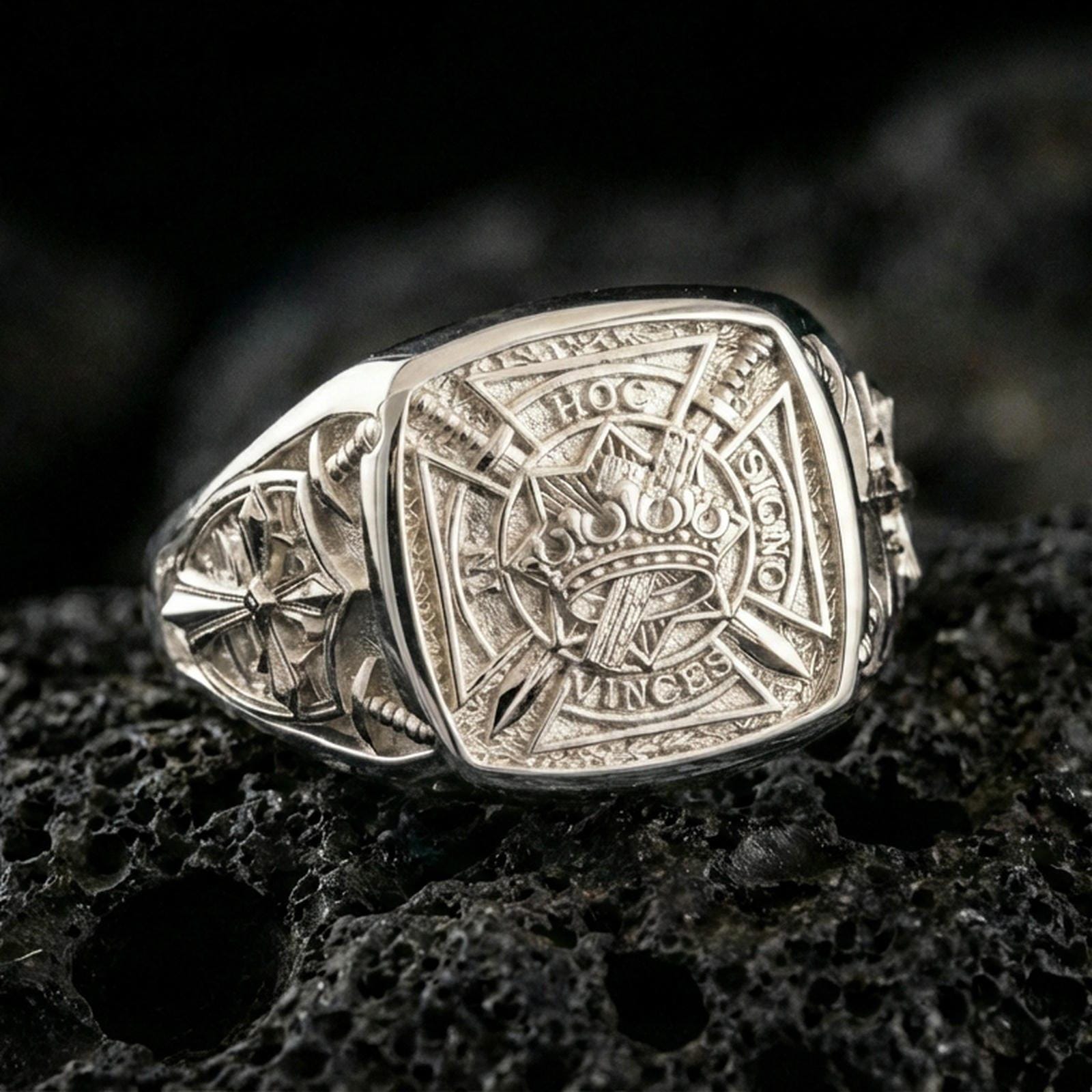 Sterling silver Crusader signet ring in a polished silver finish, detailed Templar-style heraldic shield with cross motifs and medieval engraving, close-up on volcanic stone