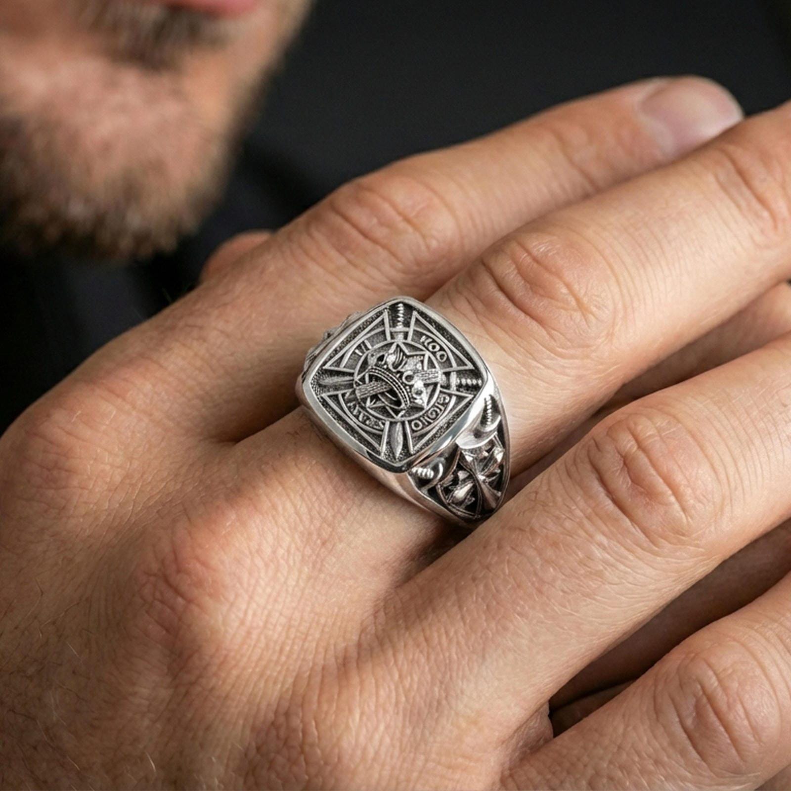 Sterling silver Crusader signet ring on a finger, macro lifestyle image emphasizing the polished silver finish and detailed medieval Templar-style shield engraving