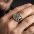 Load image into Gallery viewer, Sterling silver Templar shield ring worn on a finger, close-up lifestyle shot highlighting the oxidized finish and engraved crusader cross, crown and sword emblem
