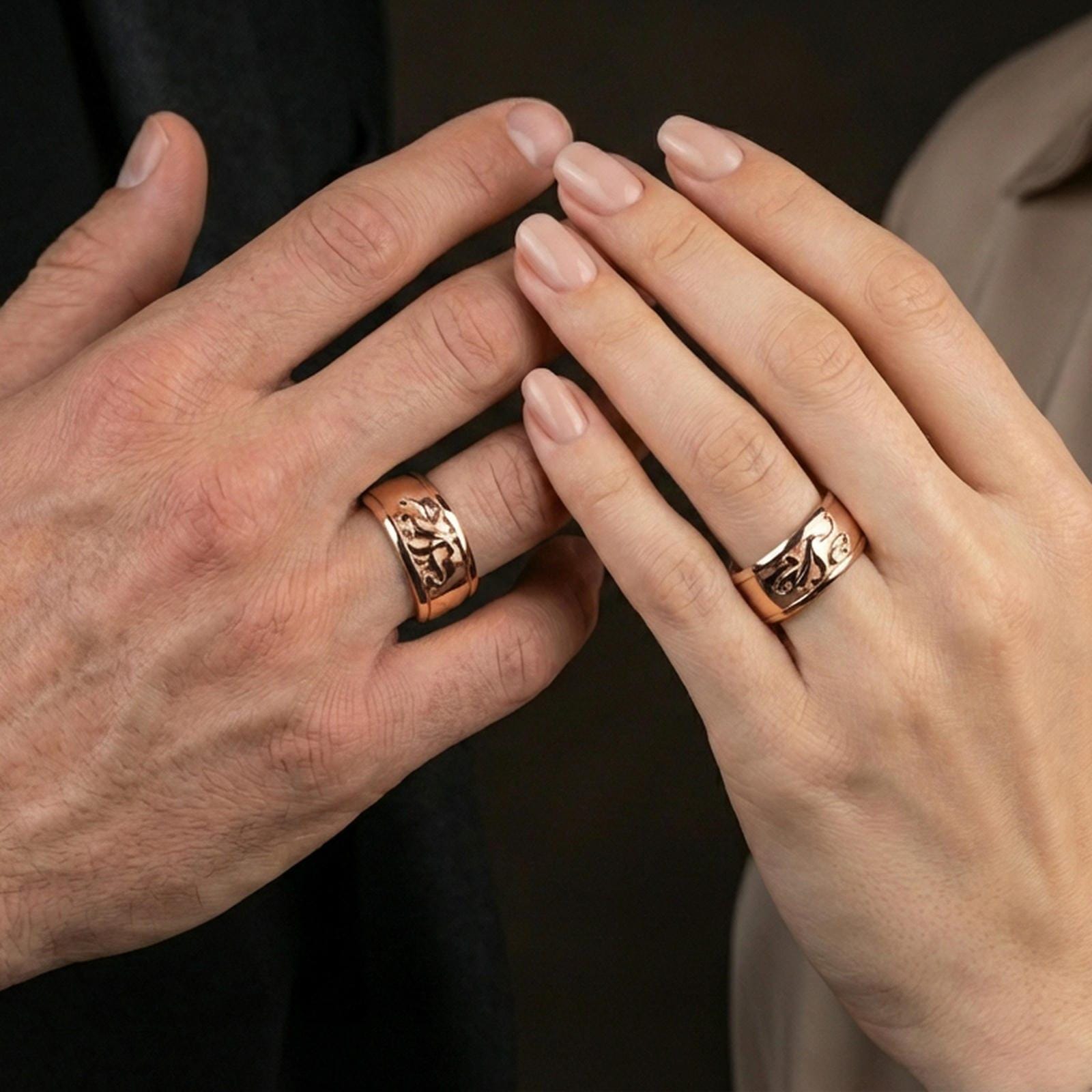 Rose gold plated octopus spinner ring worn on finger, sculpted octopus relief detail, elegant lifestyle wear shot.