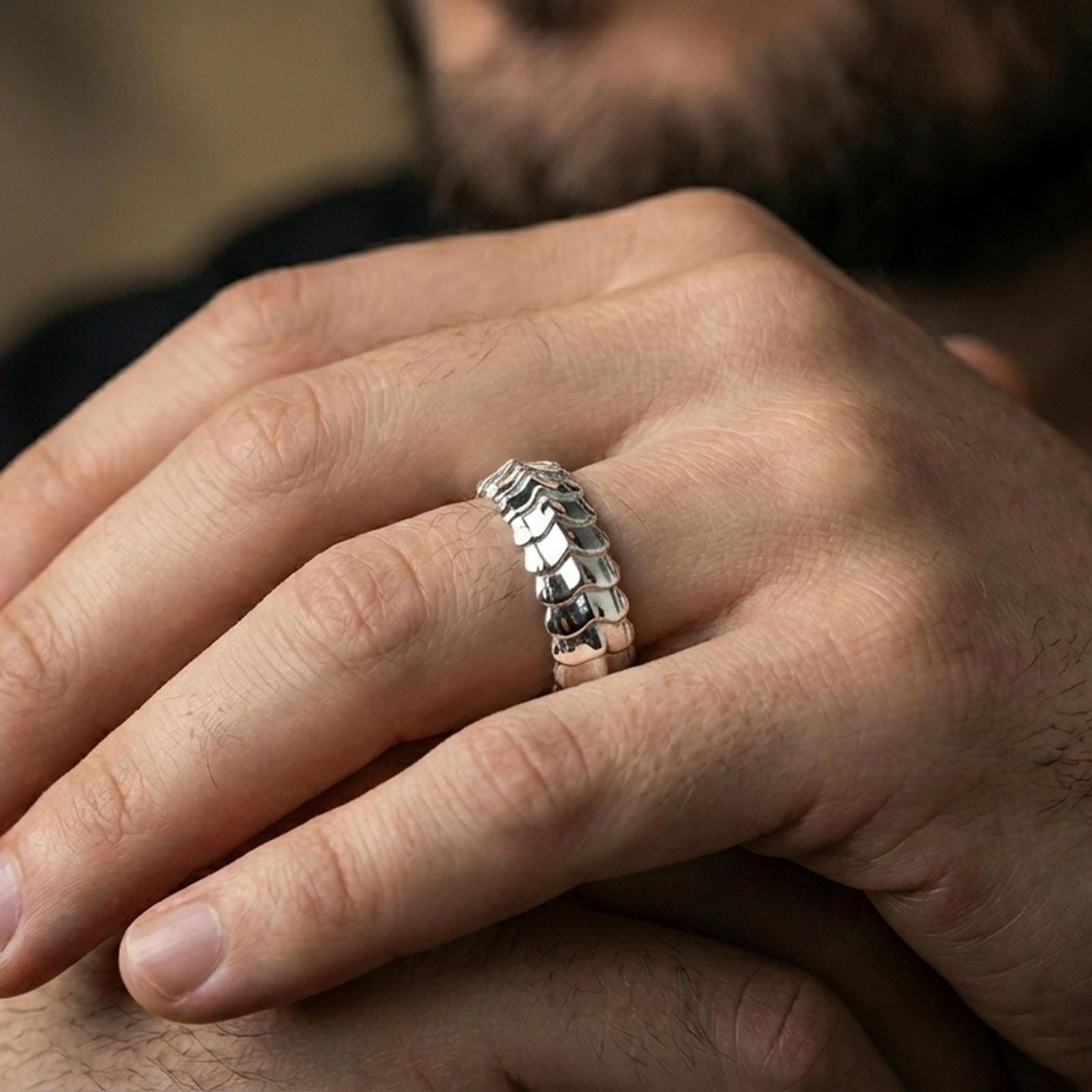 Polished silver gothic dragon scale band ring on finger, crisp layered ridges and sculpted texture, refined everyday wear close-up.