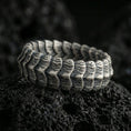 Load image into Gallery viewer, Oxidized sterling silver dragon scale band ring on dark volcanic rock, rugged segmented ridge texture with deep contrast, premium macro product shot.
