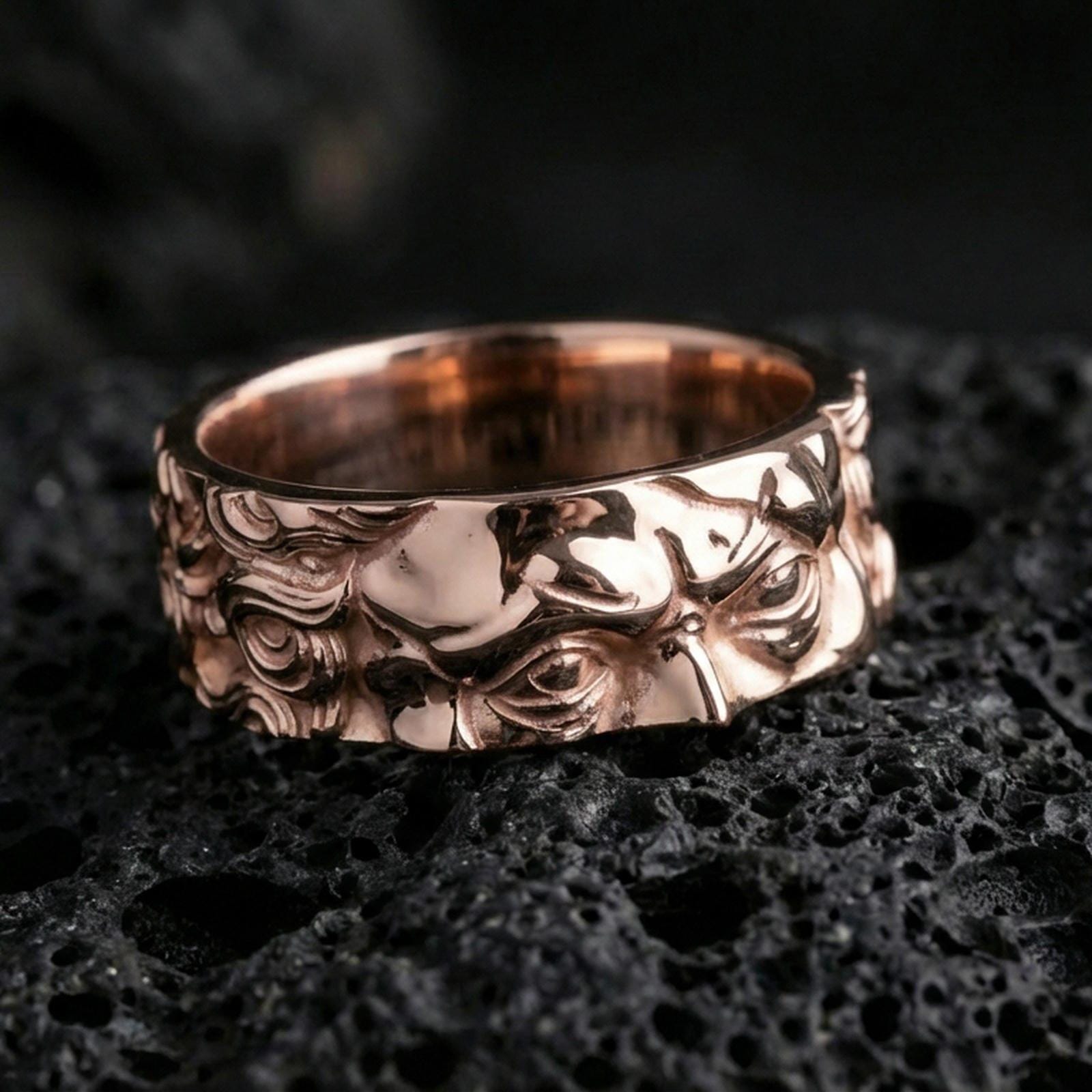 Rose gold plated sterling silver Moses spinner ring on volcanic stone, sculpted Renaissance portrait relief with deep contrast and clean borders, minimal high-end close-up.