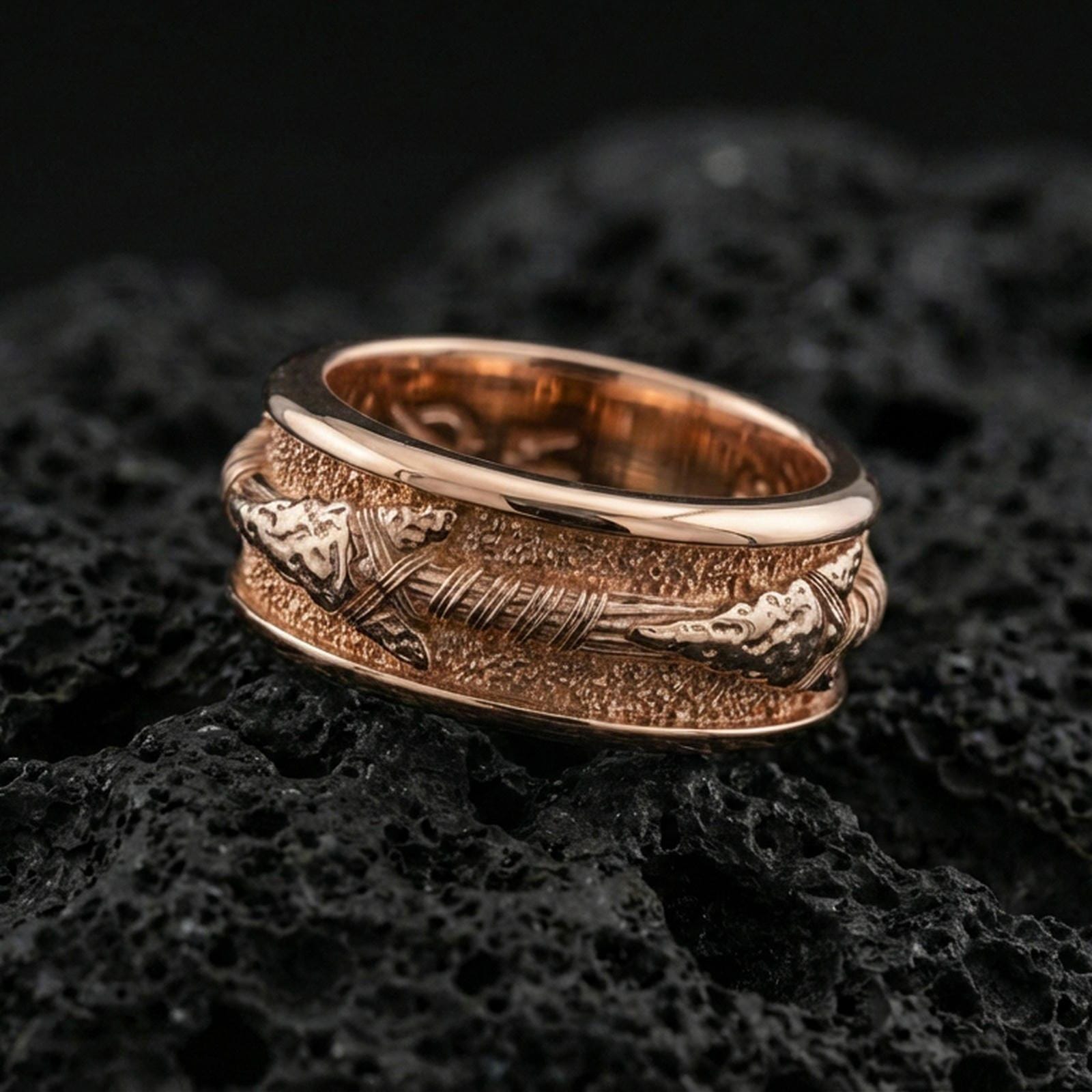 Rose gold plated sterling silver arrow spinner ring on volcanic stone, sculpted arrowhead and wrapped shaft relief with deep contrast, minimal high-end close-up.