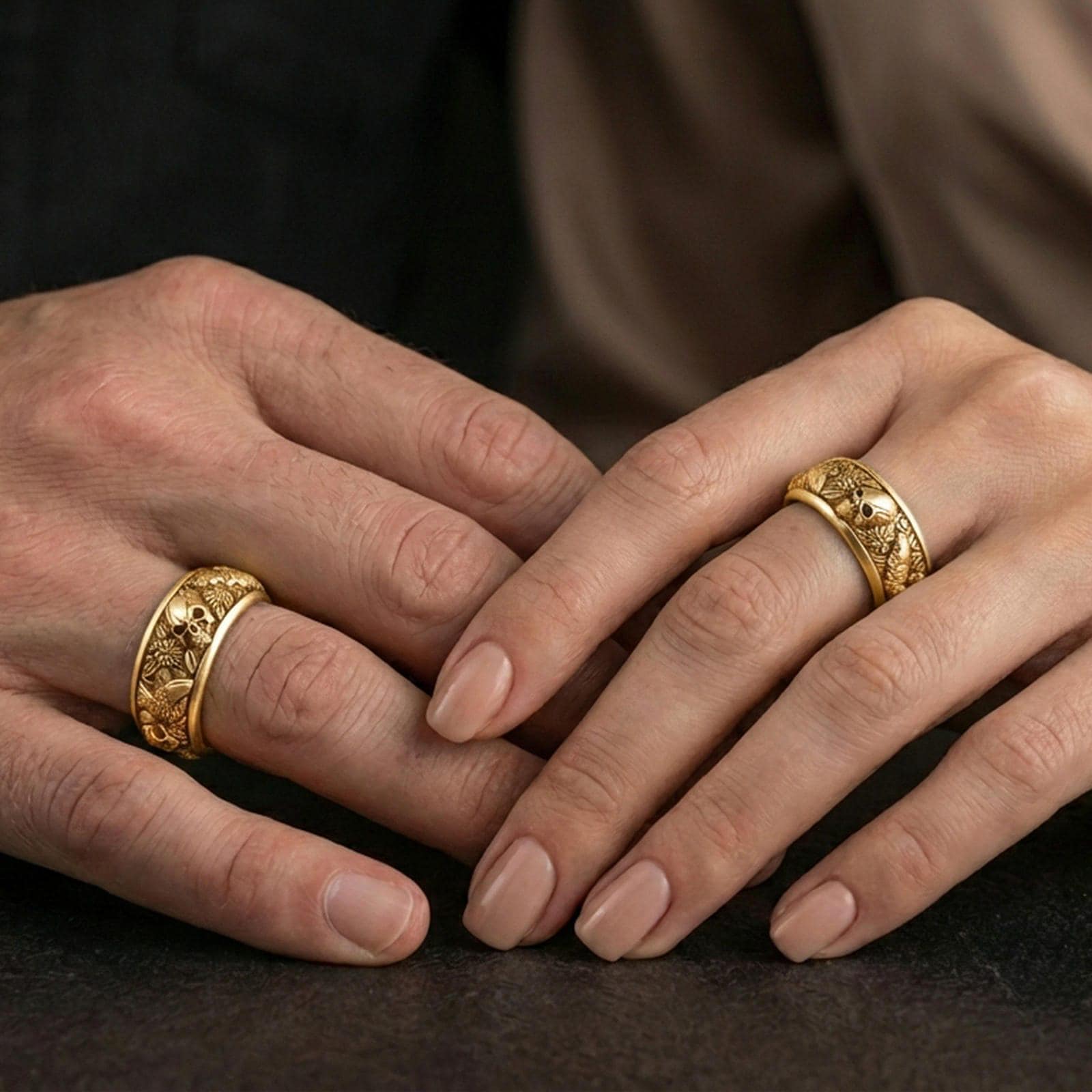 Gold plated skull and koi spinner band worn on finger, detailed skull relief with carp and wave motifs on rotating band, premium lifestyle jewelry photo.