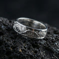 Load image into Gallery viewer, Polished silver nature tree roots band ring on black volcanic stone, crisp branch relief with leaf details and smooth comfort edges, centered close-up studio lighting.
