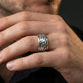 Load image into Gallery viewer, Polished silver flame swirl engraved band ring on finger, crisp flowing fire relief and smooth edges, refined everyday wear close-up.
