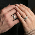 Load image into Gallery viewer, Polished silver hammered organic ring worn on finger, clean reflective finish emphasizing the stone-like surface texture, daily wear shot.
