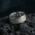 Load image into Gallery viewer, Polished silver square-grid pattern band on volcanic rock, crisp reflections on the raised borders highlighting the geometric relief, premium close-up.
