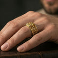 Load image into Gallery viewer, Gold plated gothic skull mechanical ring worn on finger, rich warm tone accenting the skull and gear motif, lifestyle jewelry shot.
