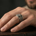 Load image into Gallery viewer, Oxidized sterling silver skull gear ring worn on finger, high-contrast detailing on the skull and industrial patterns, lifestyle hand close-up.
