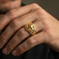 Load image into Gallery viewer, Gold plated North Star statement ring worn on finger, rich warm shine defining the compass star edges and sculpted ornamental band.
