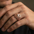 Load image into Gallery viewer, Rose gold plated North Star compass ring worn on finger, refined warm glow with crisp star points and elegant engraved scroll detailing.
