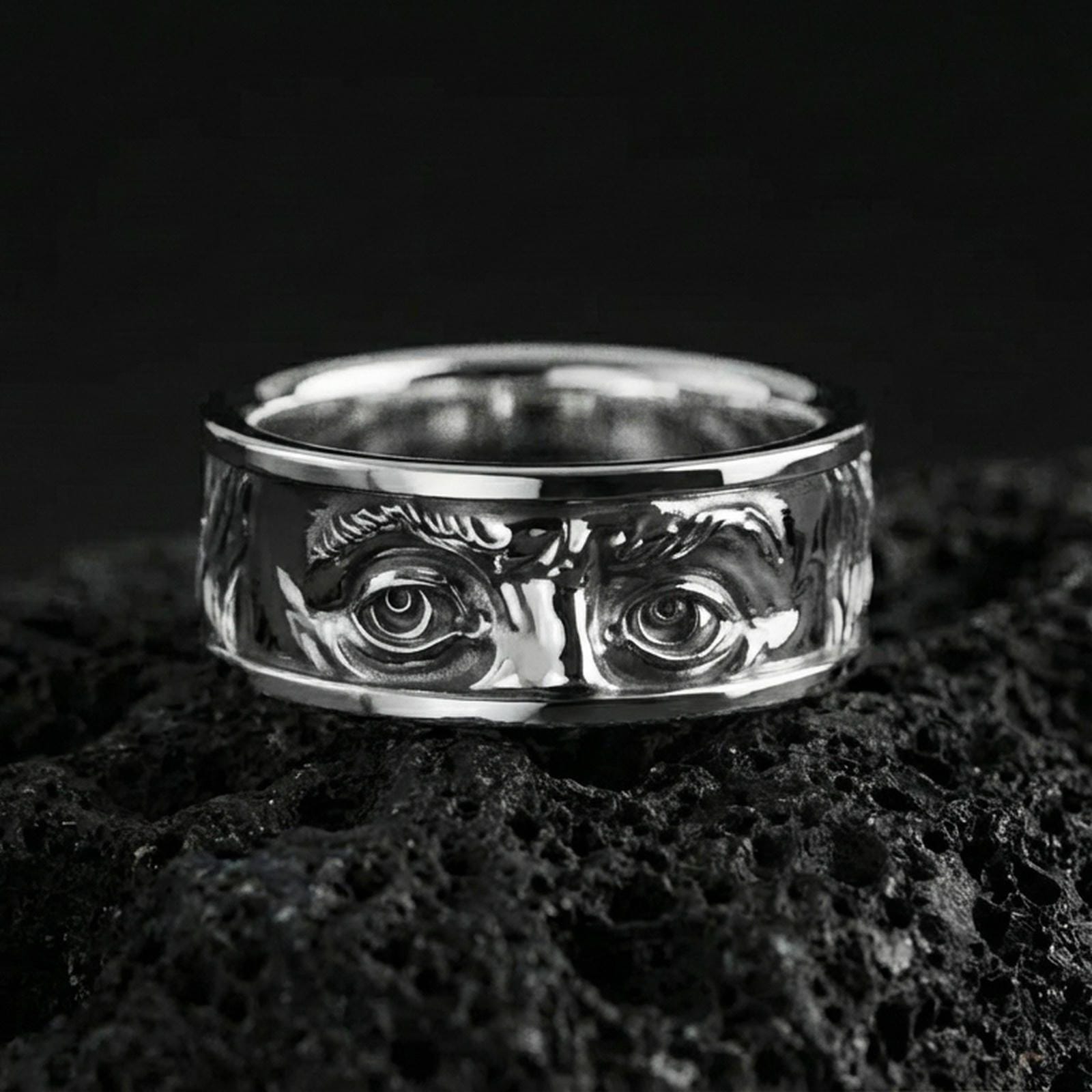 Polished silver Benjamin Franklin portrait ring on volcanic rock, crisp eye detailing with a clean reflective finish and smooth comfort edges.