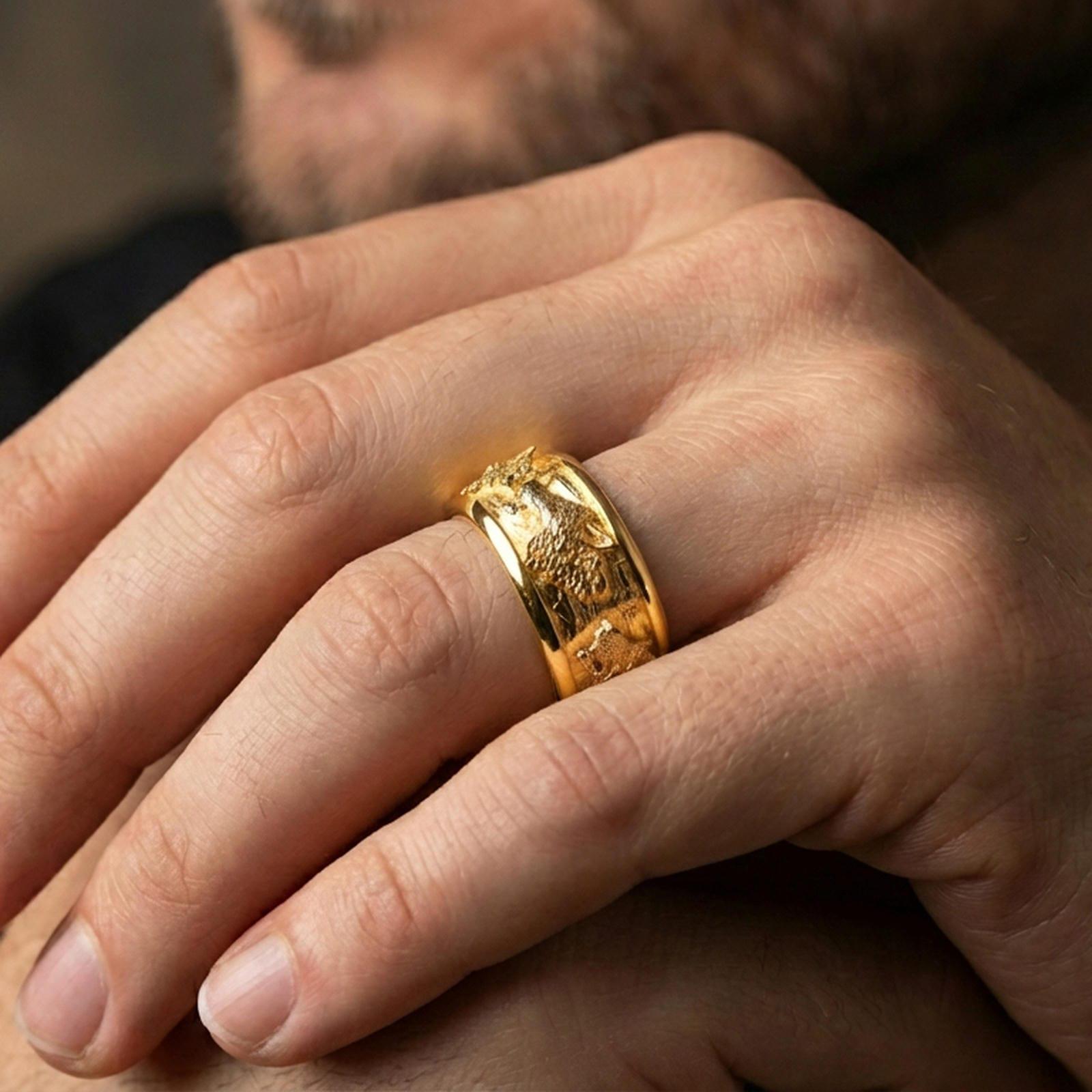 Gold plated wolf spinner ring worn on a finger, warm reflective finish highlighting the wolf heads and forest motif.
