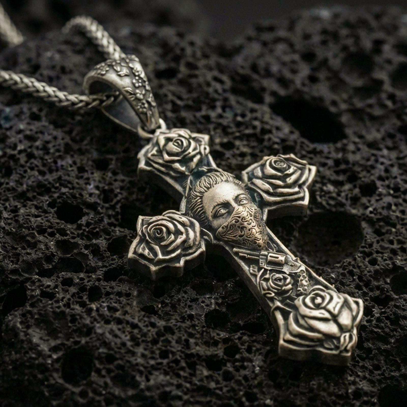 Bronze Chicano tattoo style cross pendant with rose details and masked face motif displayed on dark volcanic rock in a close-up luxury jewelry shot