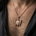 Load image into Gallery viewer, Rose gold plated spiritual protection pendant with winged shield and Quis Ut Deus engraving worn on the neck in a refined lifestyle shot with a masculine presentation
