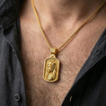 Load image into Gallery viewer, Gold plated Jesus portrait pendant with staff and engraved border worn on the neck in a premium lifestyle composition with classic Christian jewelry styling
