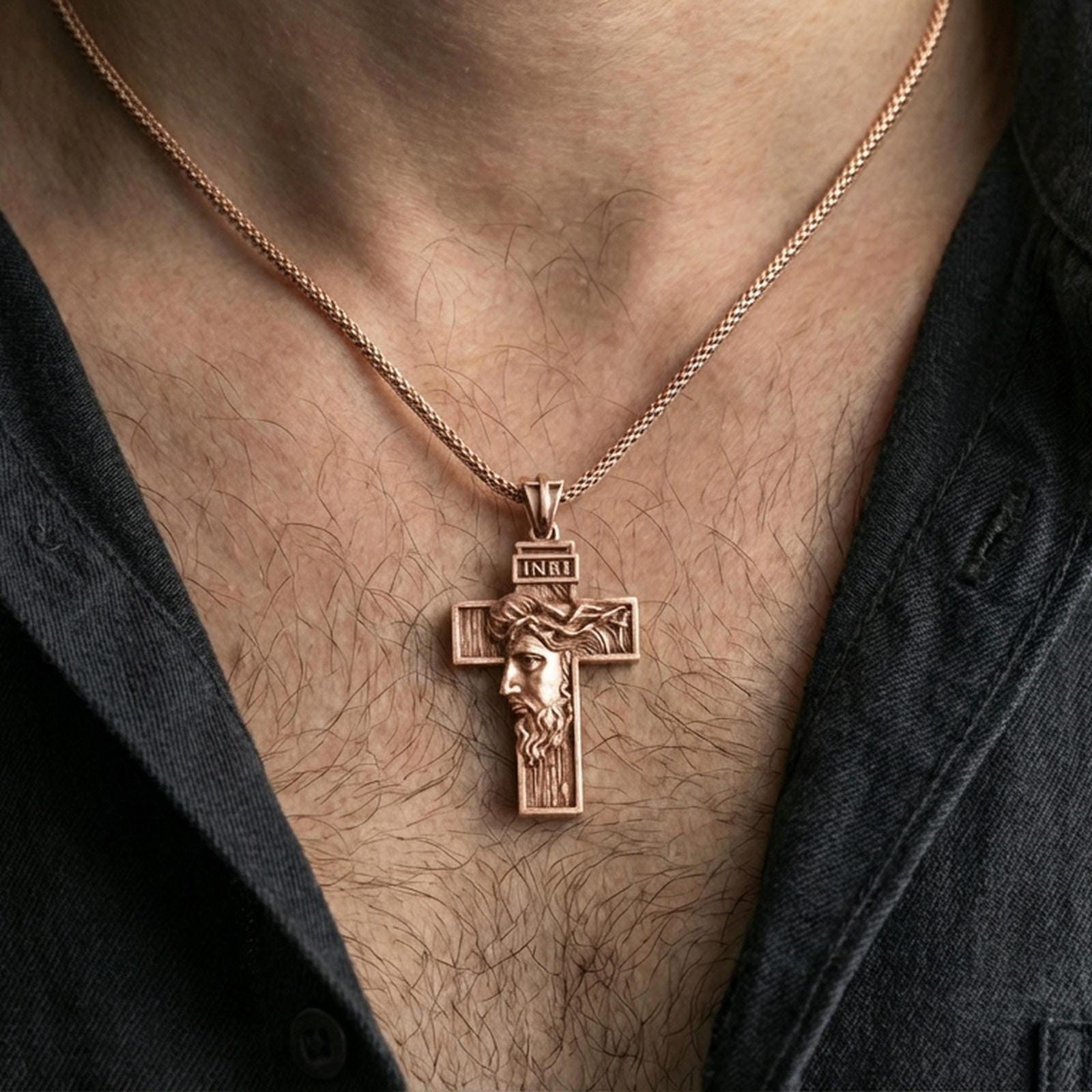 Rose gold plated Christ cross pendant with detailed face relief and INRI plaque worn on the neck in a refined lifestyle shot with a warm and elegant presentation