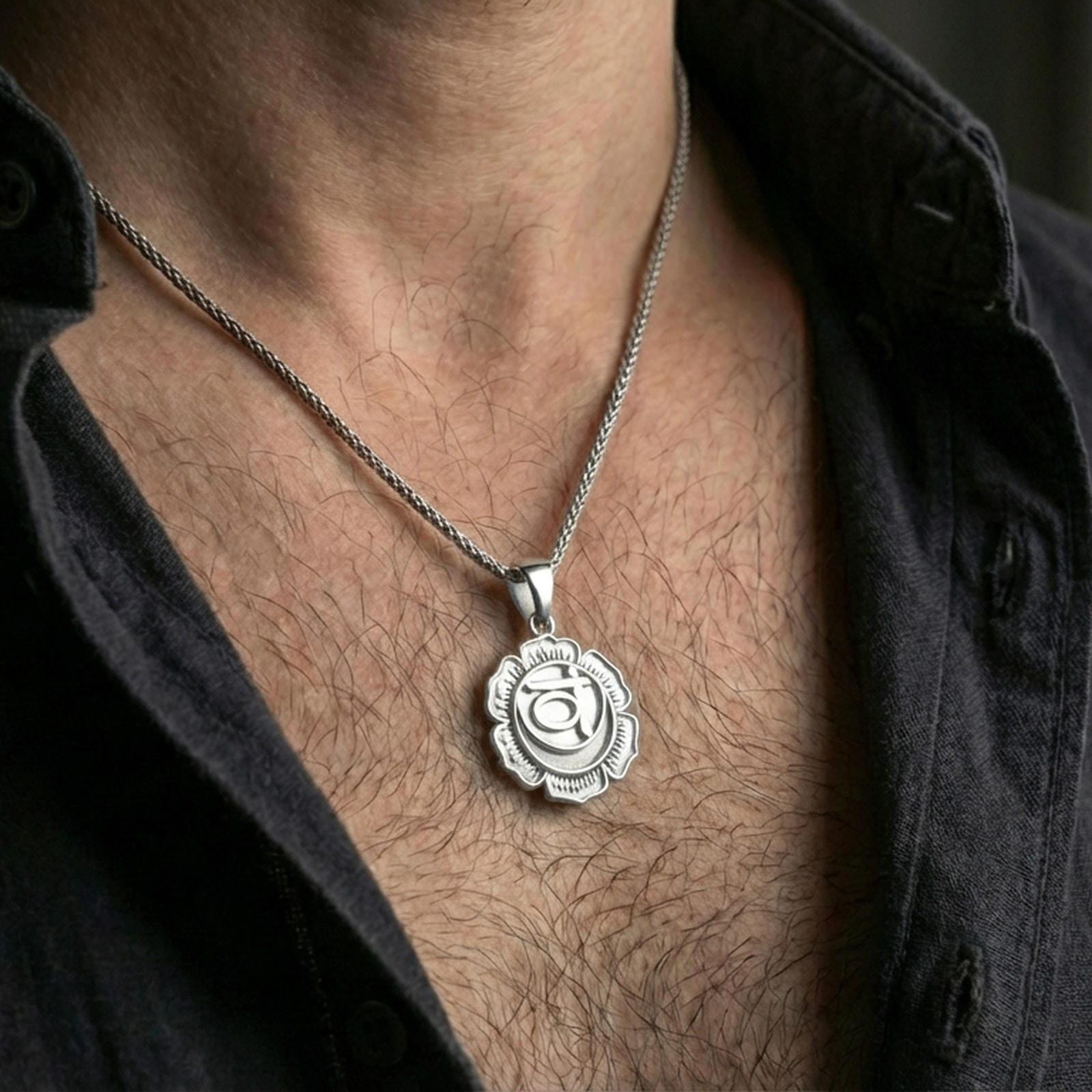 Polished silver lotus chakra pendant worn on the neck in a close lifestyle frame, highlighting the sacred symbol and layered floral design