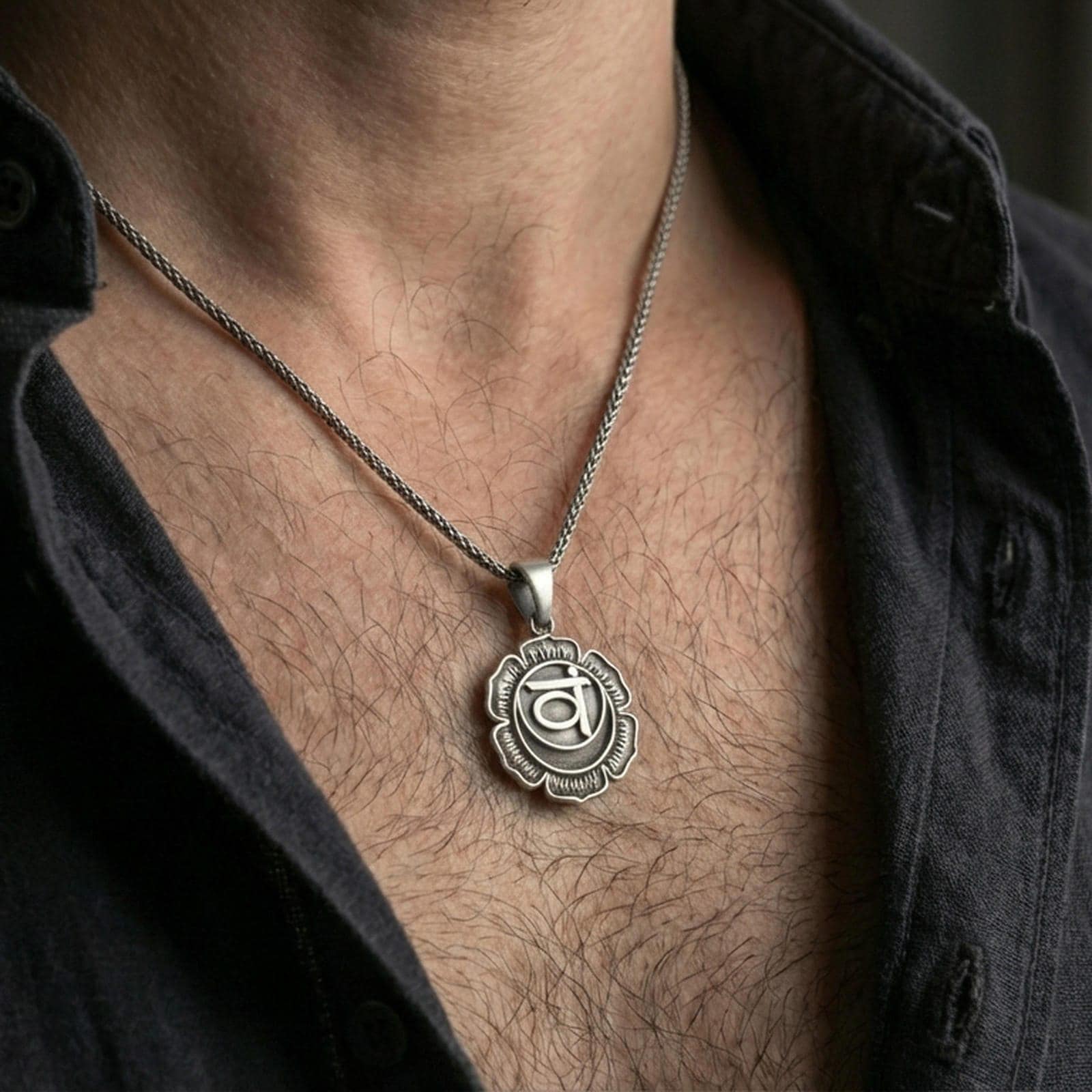 Oxidized throat chakra pendant worn on the neck in a lifestyle jewelry shot, styled against the chest for a bold and spiritual look