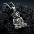 Load image into Gallery viewer, Sterling silver Khnum pendant with an oxidized finish, Egyptian ram-headed deity seated in meditation with detailed robe texture, macro on black volcanic rock
