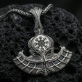 Load image into Gallery viewer, Sterling silver Viking axe pendant with an oxidized finish, detailed double-blade design featuring a Vegvisir compass symbol, close-up on black volcanic rock
