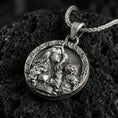 Load image into Gallery viewer, Sterling silver Freya goddess medallion pendant with an oxidized finish, Norse goddess portrait with cat companion relief, close-up on black volcanic rock
