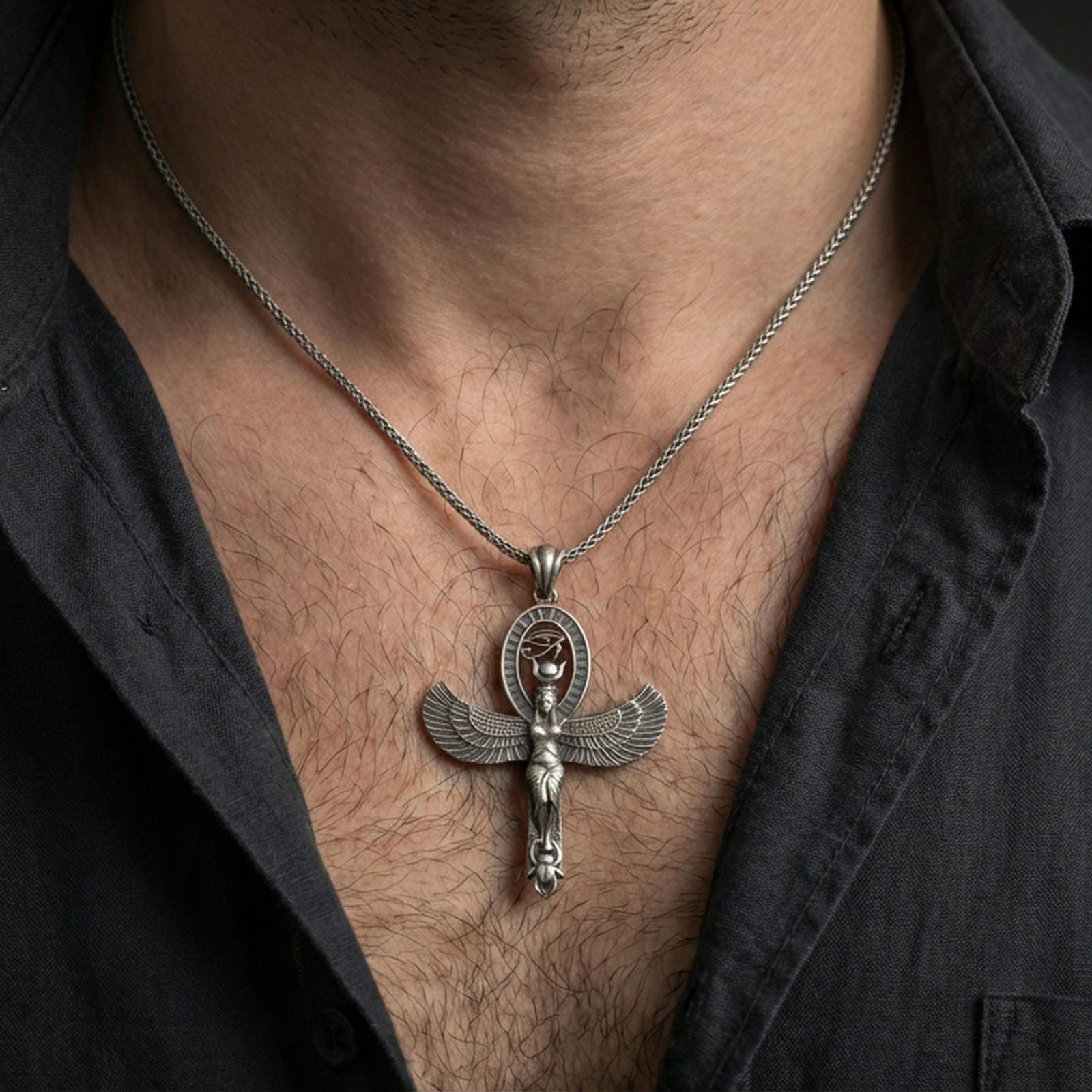 Sterling silver Egyptian Isis winged pendant necklace worn on the neck, close-up lifestyle shot highlighting the oxidized finish and feather wing details
